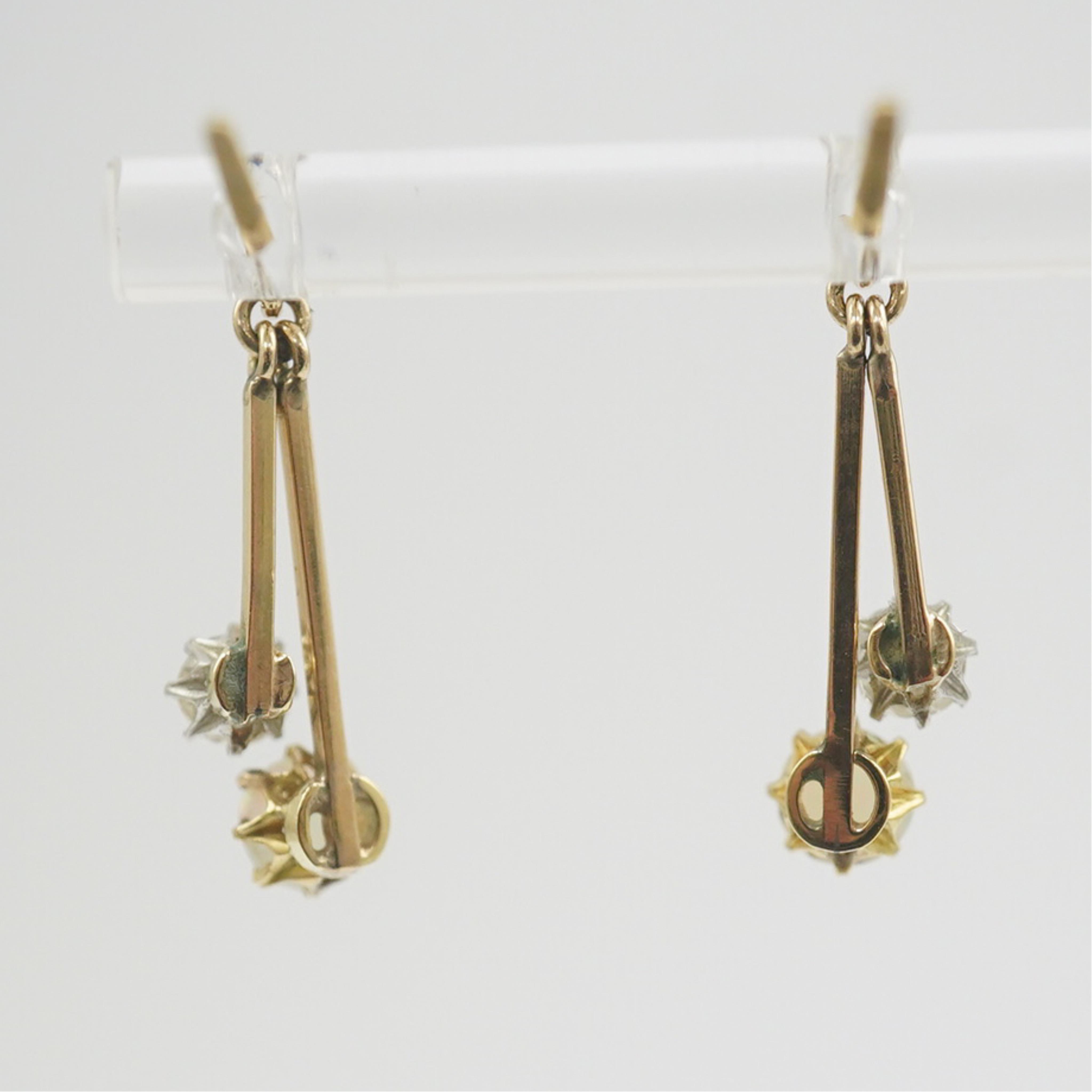 A pair of 9ct gold, white opal and diamond set double drop earrings